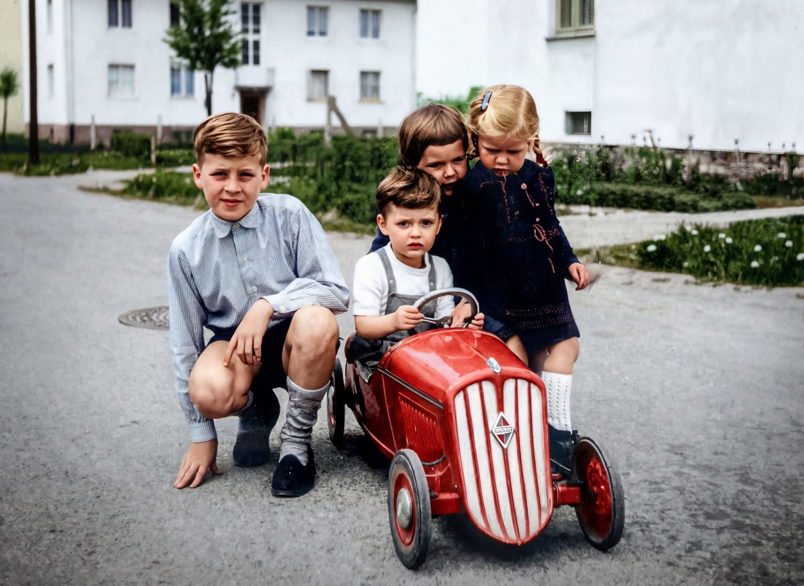 Kinder um ein Tretauto im Stil Borgward von 1965