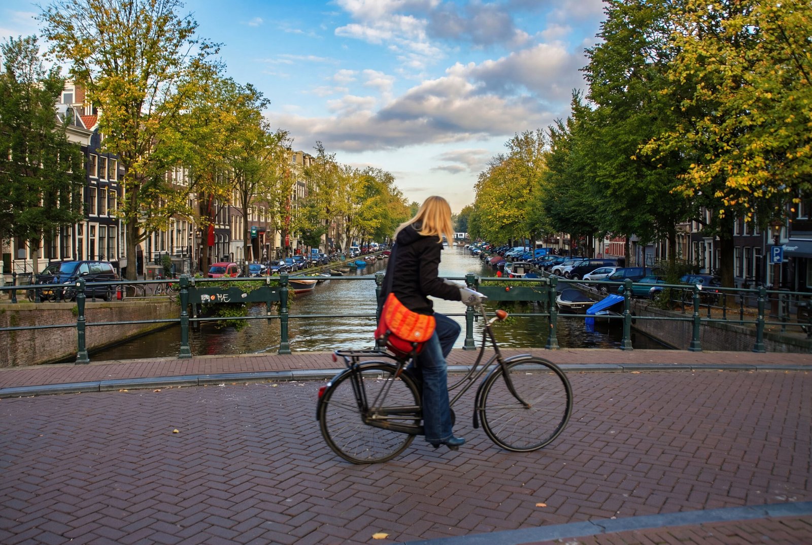 Fahrradfahrerin auf einer Brücke, Gracht, Amsterdam
