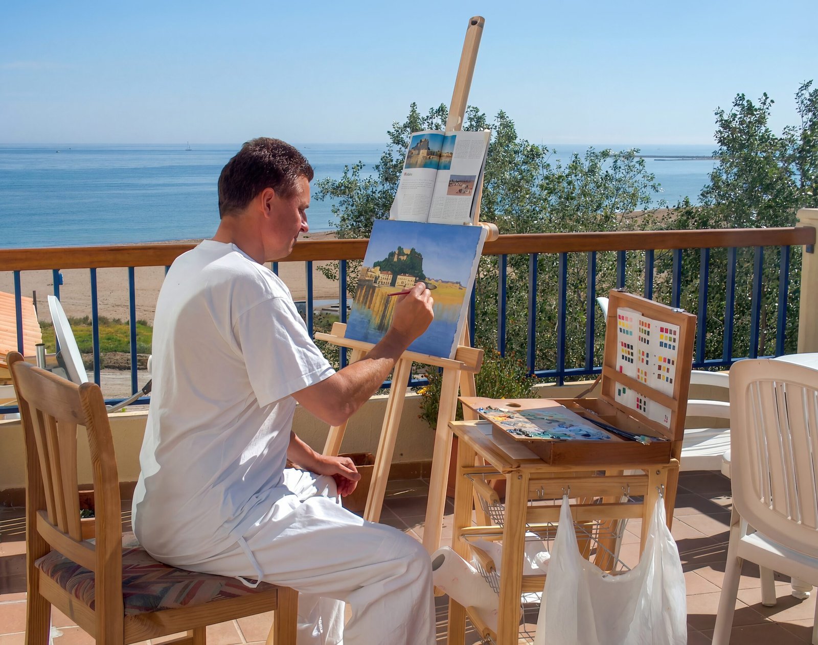 Ein Maler malt ein Ölbild vom Castillo de Dénia
